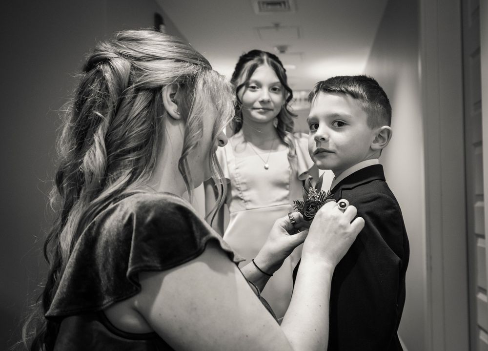 A series of intimate black and white photos showing tender moments between people in a dimly lit setting.