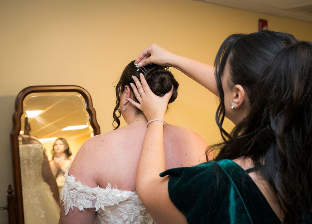 Close-up of wedding dress preparations and final touches before the ceremony.