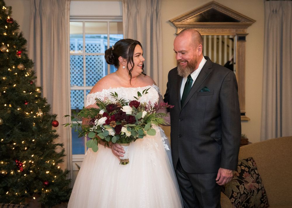 Wedding celebration in a cozy room decorated with Christmas trees and holiday accents.