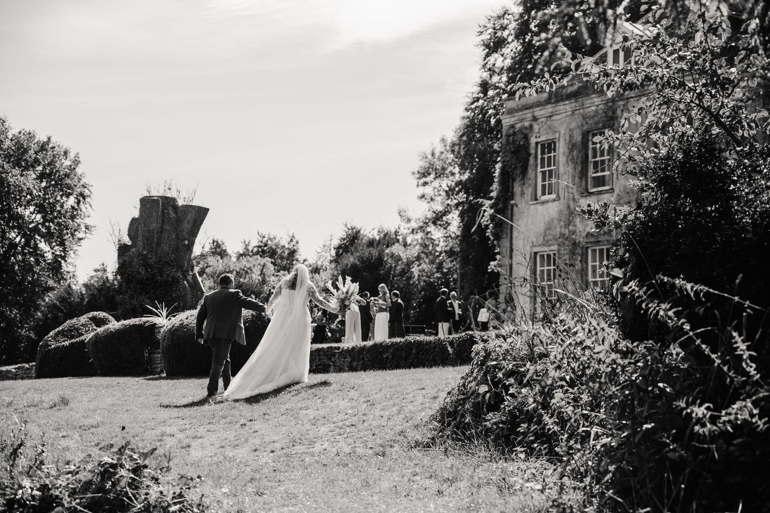 Bride and Groom explore the grounds at Holbrook Manor wedding venue near Wincanton.. From a candid Somerset Wedding Photographer