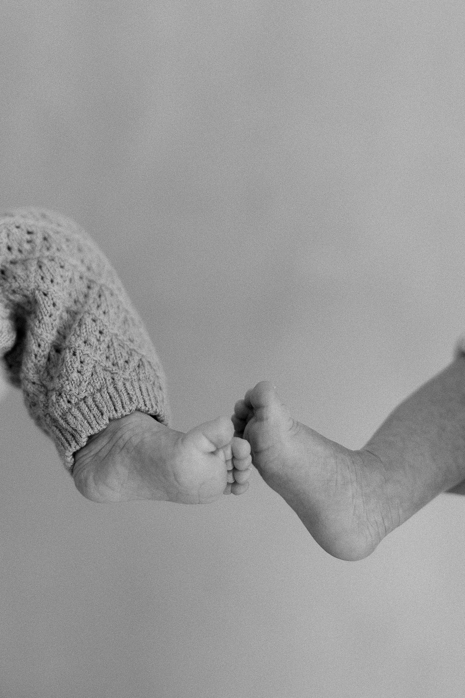 Close-up of newborn babies of twin toes in a natural pose photographed in California