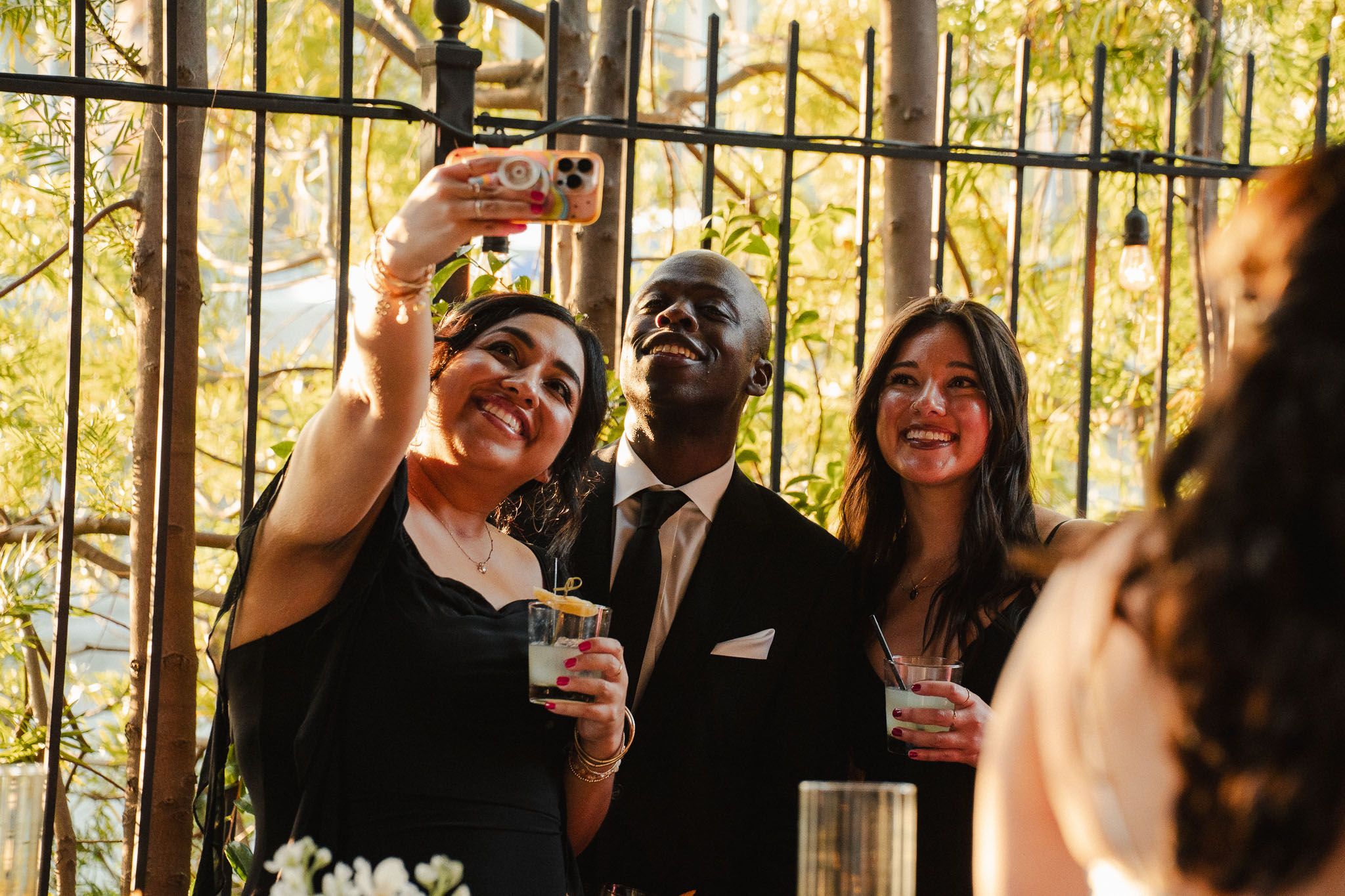 Warm evening light on guests during an intimate California wedding taking selfie