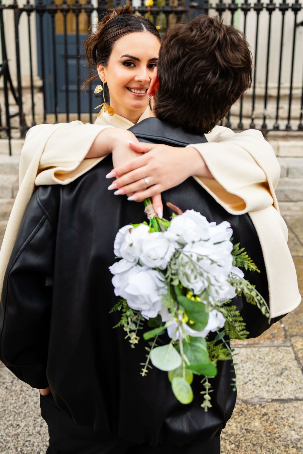 Romantic embrace with bouquet — elegant and modern anniversary photoshoot in Dublin.