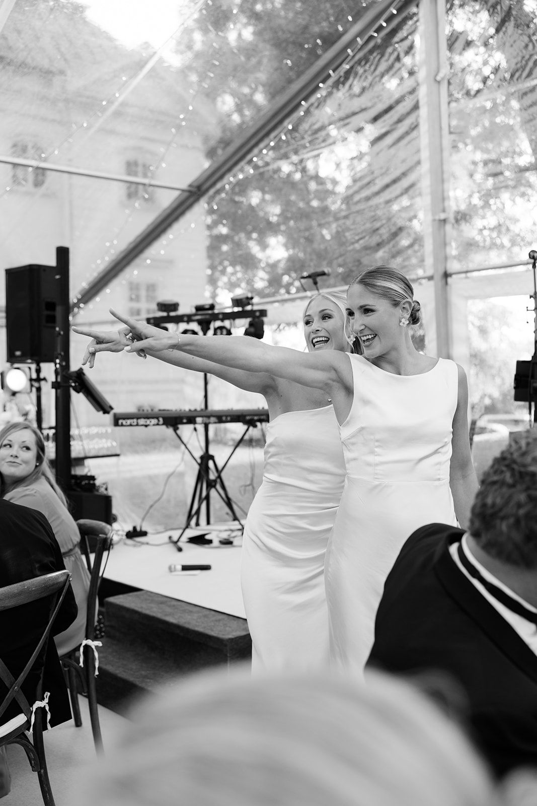 Black and white photos show a band performing under a white tent during an outdoor event.