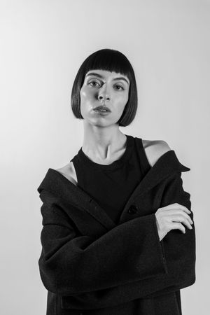 Black and white portrait series showing a person with short black bob haircut in dark clothing.