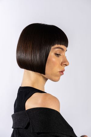 Profile views of a sleek black bob haircut against a white background showcasing the precise geometric styling.