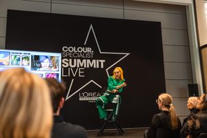 Professional event stage setup with black backdrop featuring a star logo and green lighting effects.