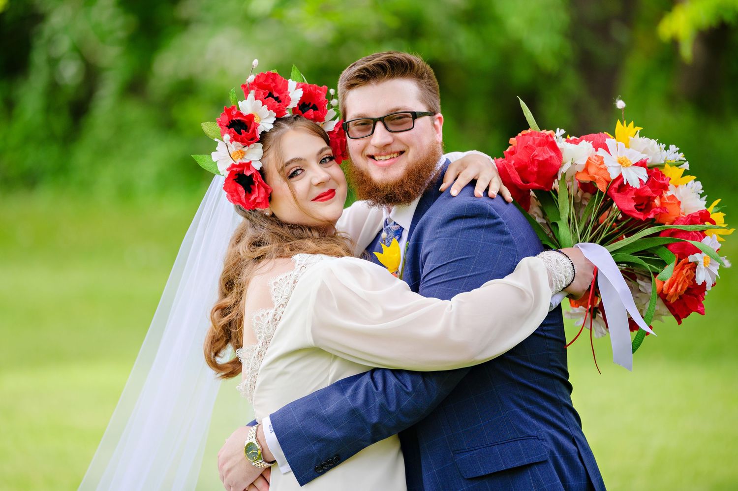 A happy wedding couple embraces outdoors before their wedding ceremony at 
St Nicholas Orthodox Church in Mogadore Ohio in May