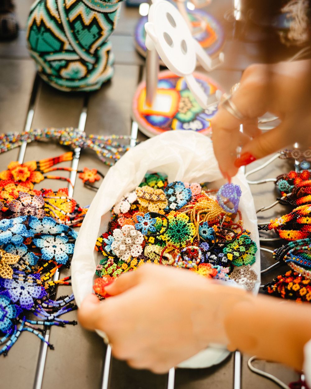 Colorful crystal brooches and jewelry pieces sparkle under display lighting.