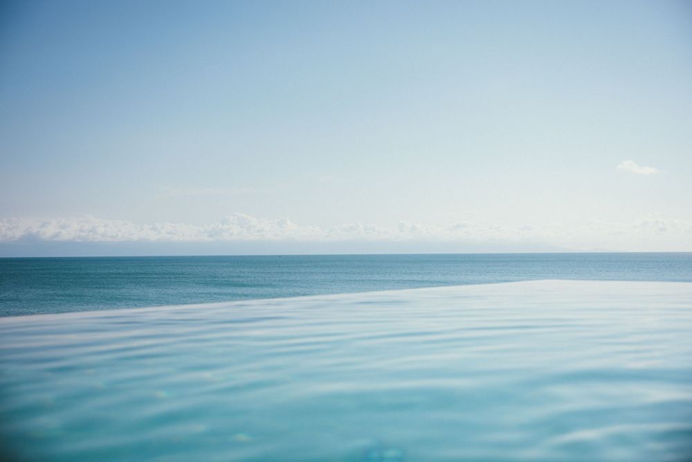 Calm turquoise ocean waters meet the horizon under a clear blue sky.