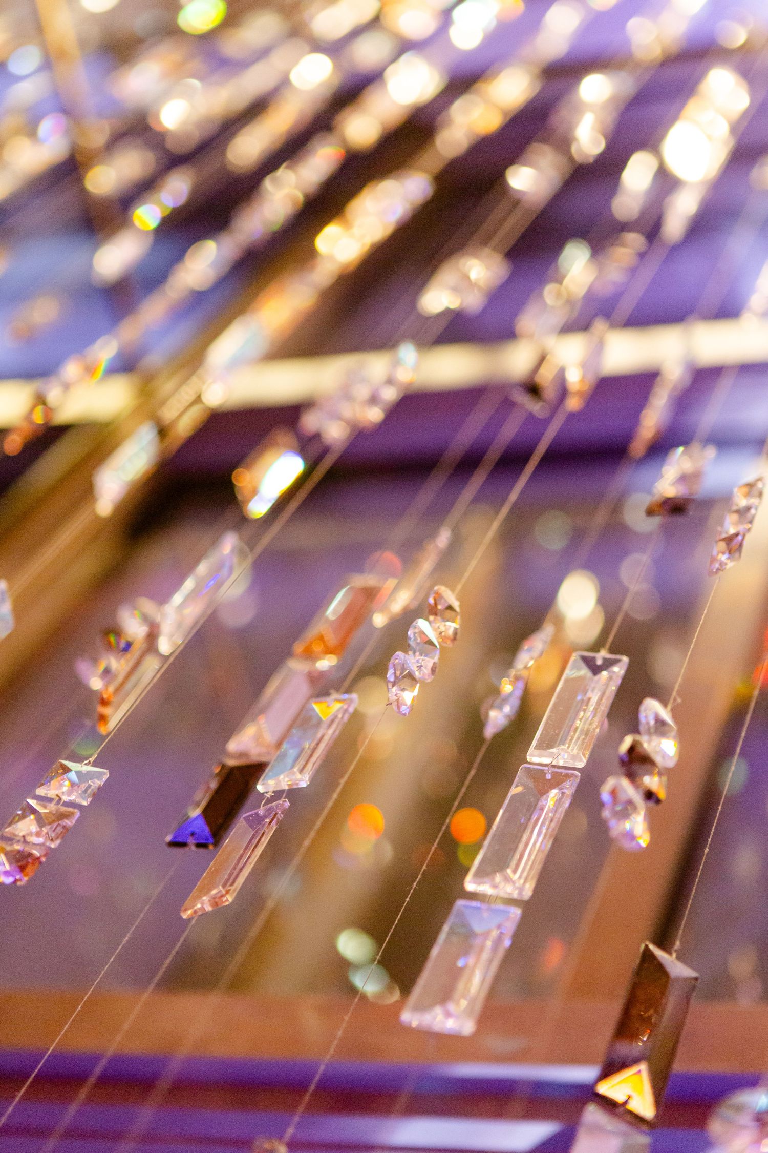 Close-up of crystal chandelier details with sparkling lights creating a bokeh effect.