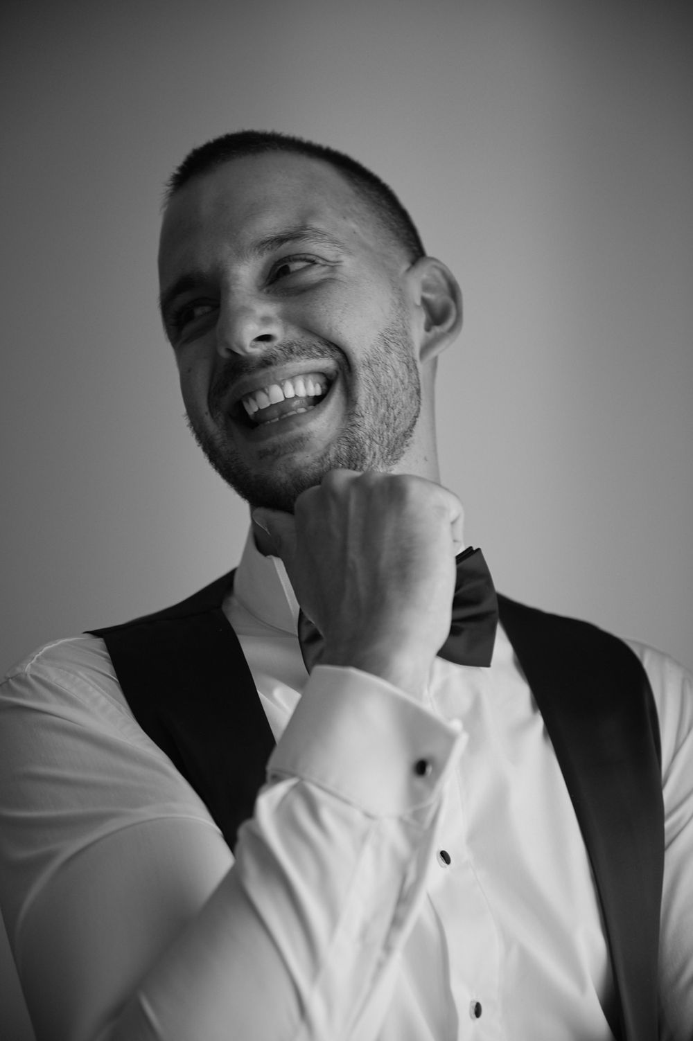 A sequence of black and white portraits showing joyful laughter and genuine emotion.