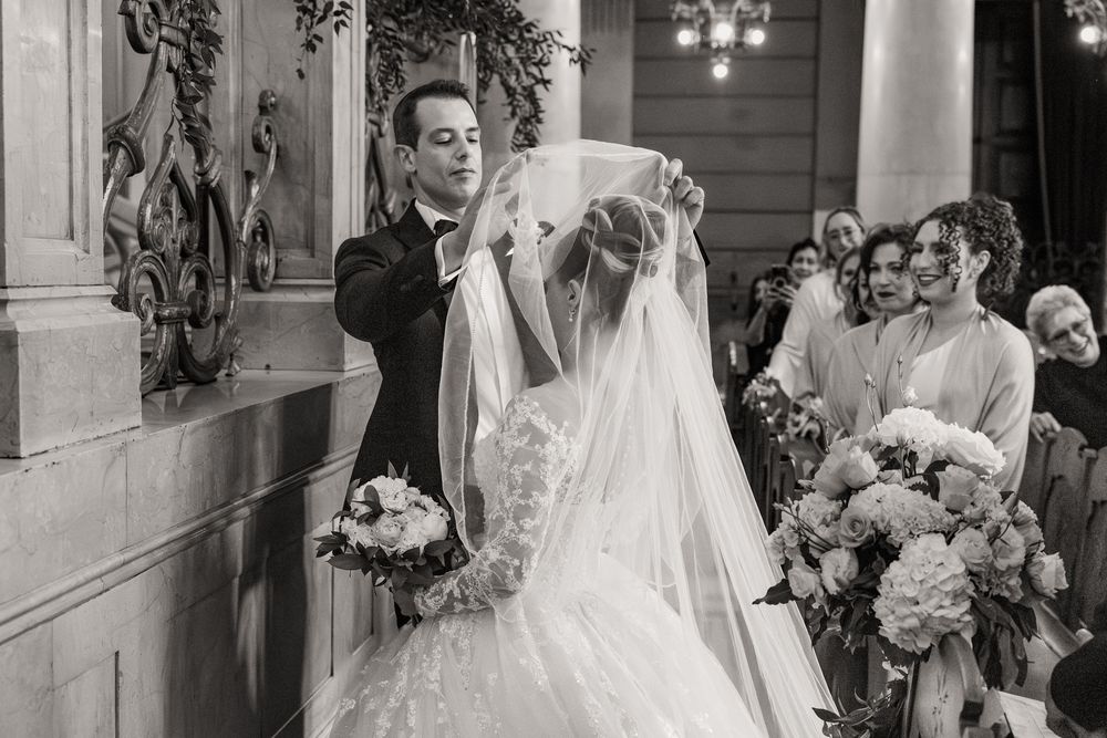 A series of black and white wedding photographs showing moments during a formal ceremony and reception.