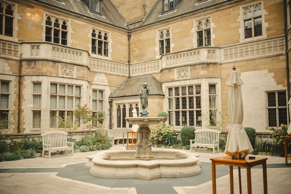Exterior courtyard of grand historic stone mansion with ornate architectural details.