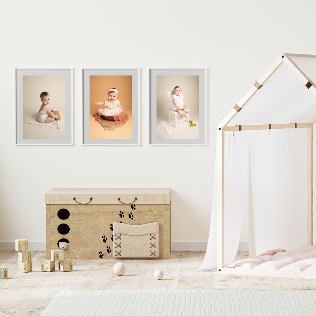 Three framed baby portrait photos displayed on a wall in a cozy children's bedroom.