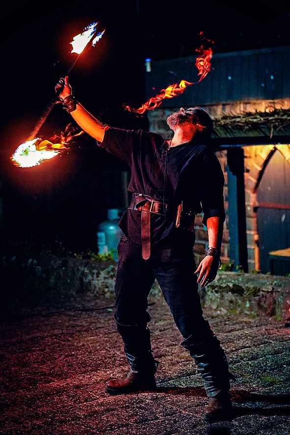 A series of dark atmospheric photos showing someone holding a flaming torch at night, creating dramatic lighting effects.