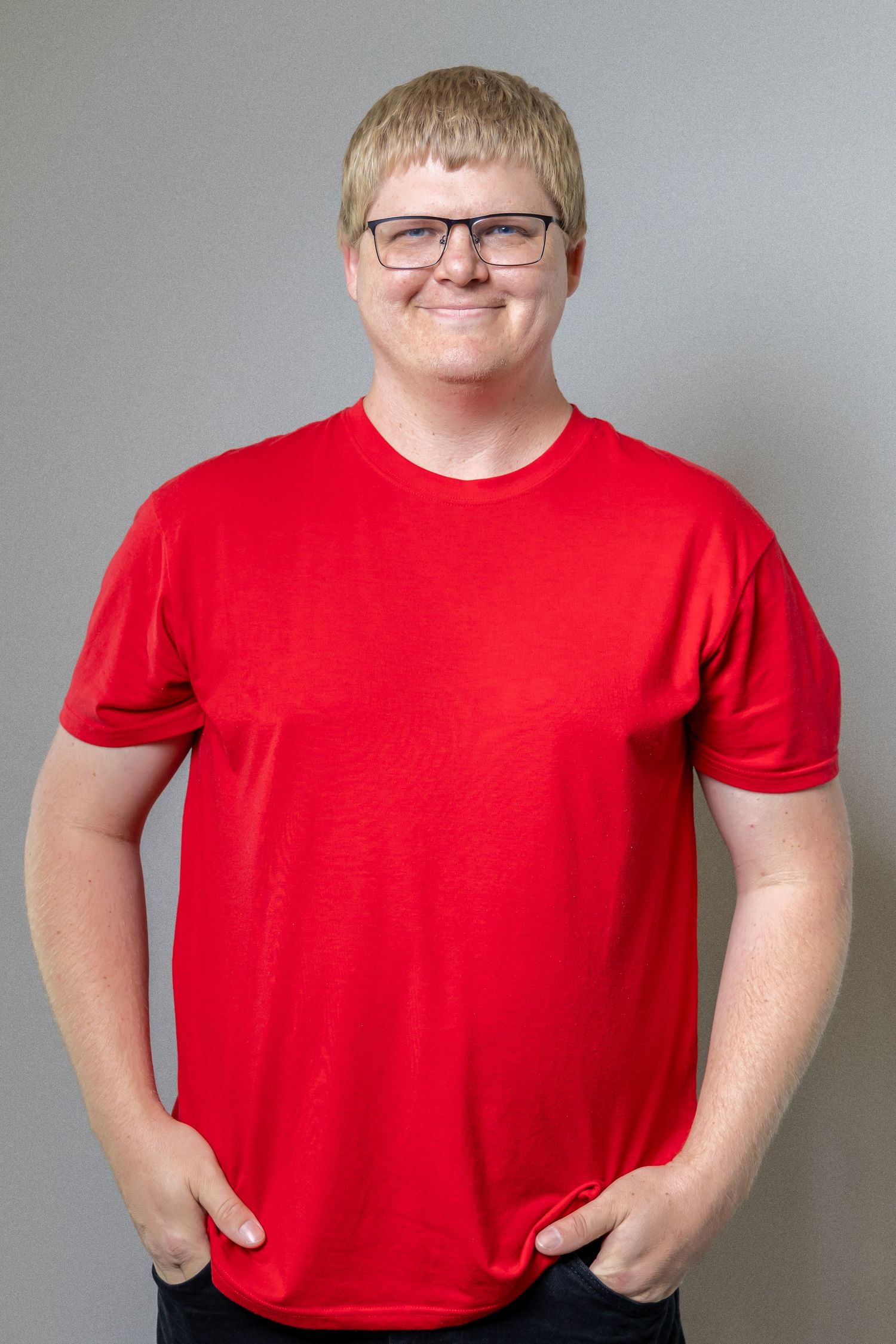 Person in a bright red t-shirt stands against a gray background in a series of similar poses.