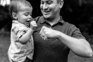 A series of black and white photographs showing tender moments between adults and young children.