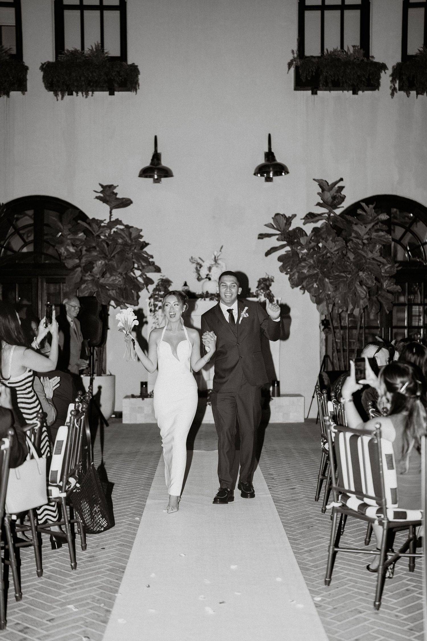 A vintage black and white photo showing people dancing at a formal indoor event.