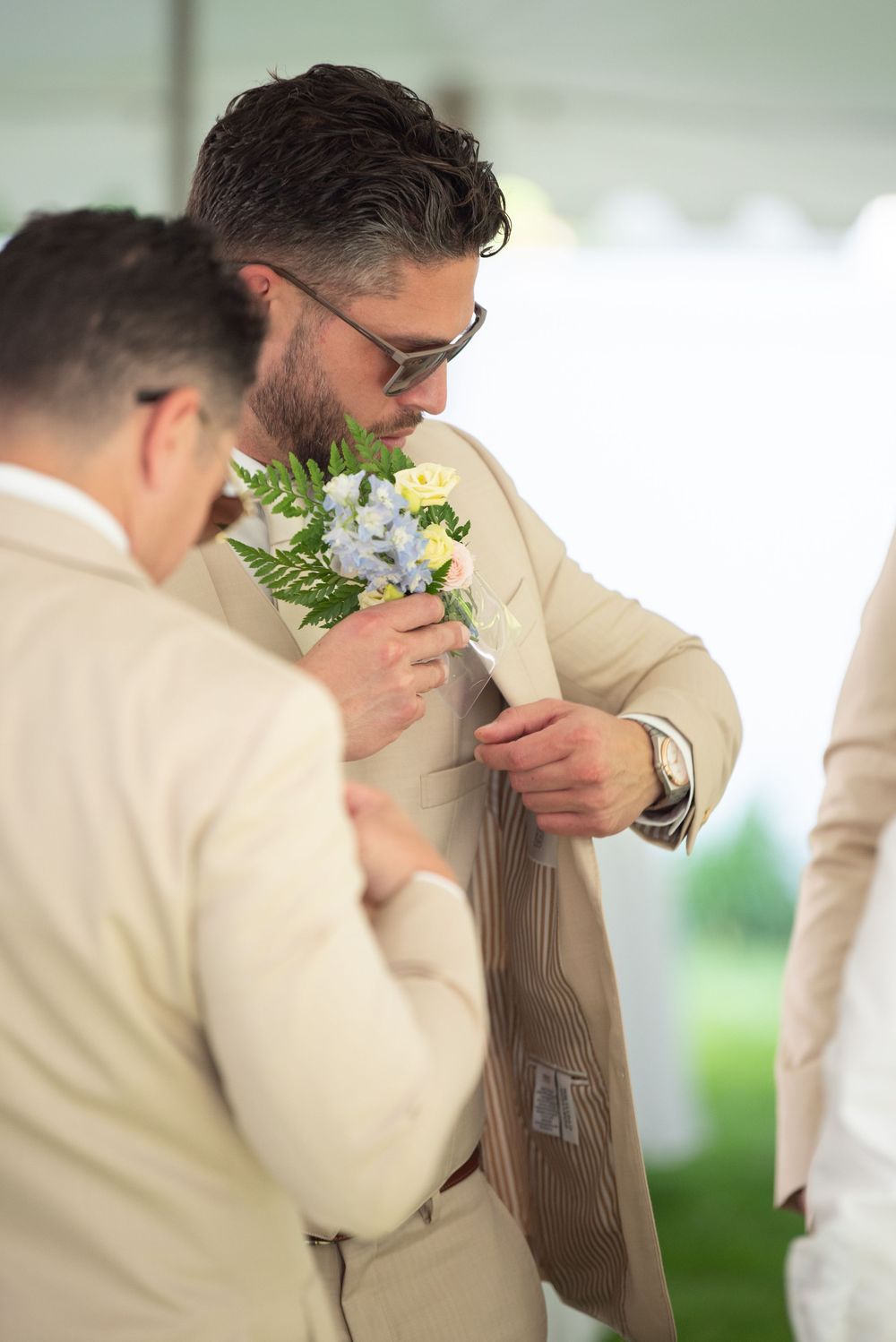 Groomsmen in beige suits smell their boutonnieres in a candid wedding photo sequence.