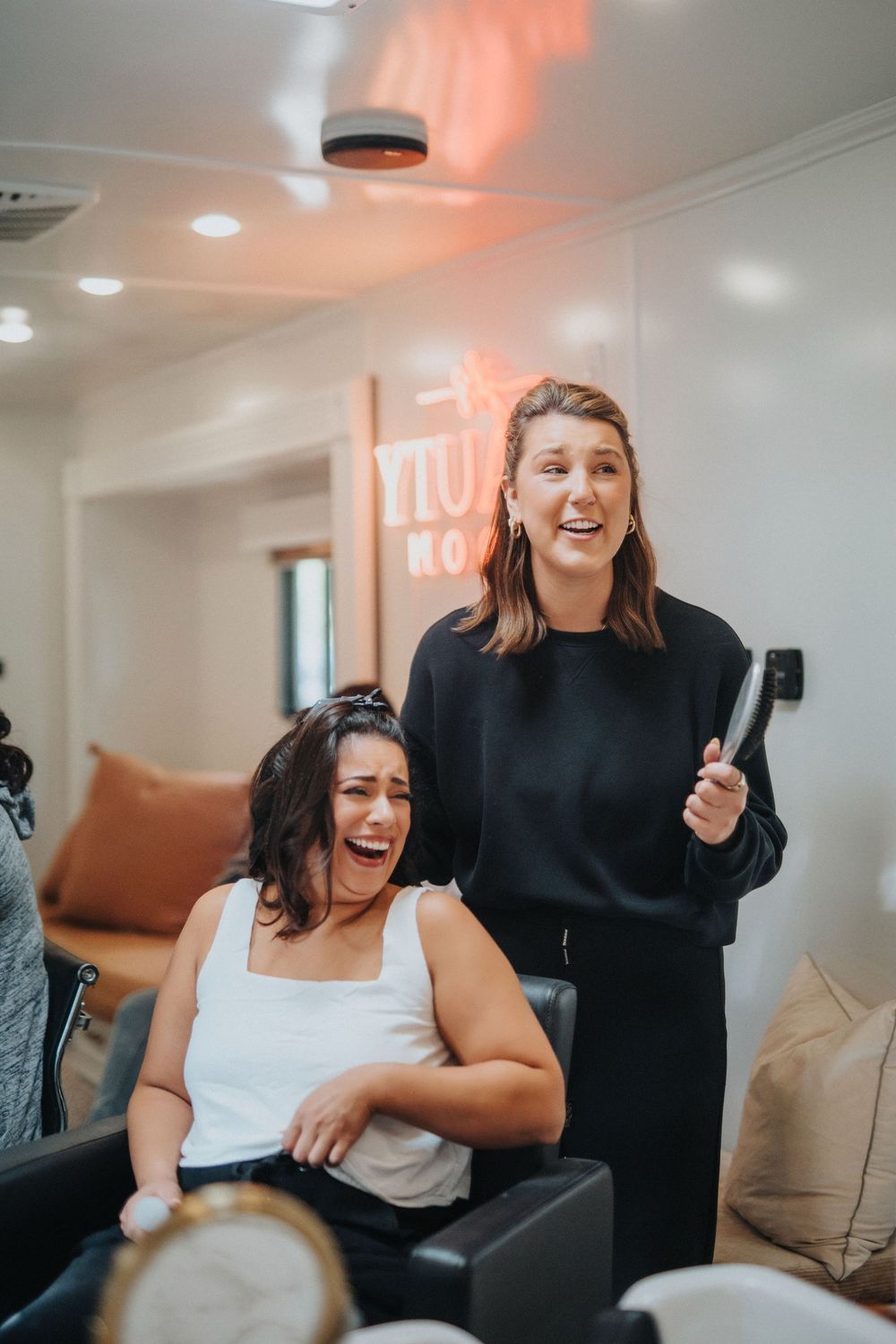 Candid moment of joyful laughter captured in a bright indoor setting.