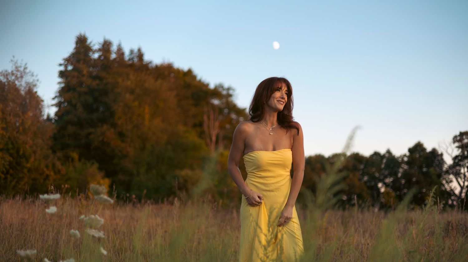 A series of outdoor portraits showing someone in a yellow dress posing in a grassy field at sunset.