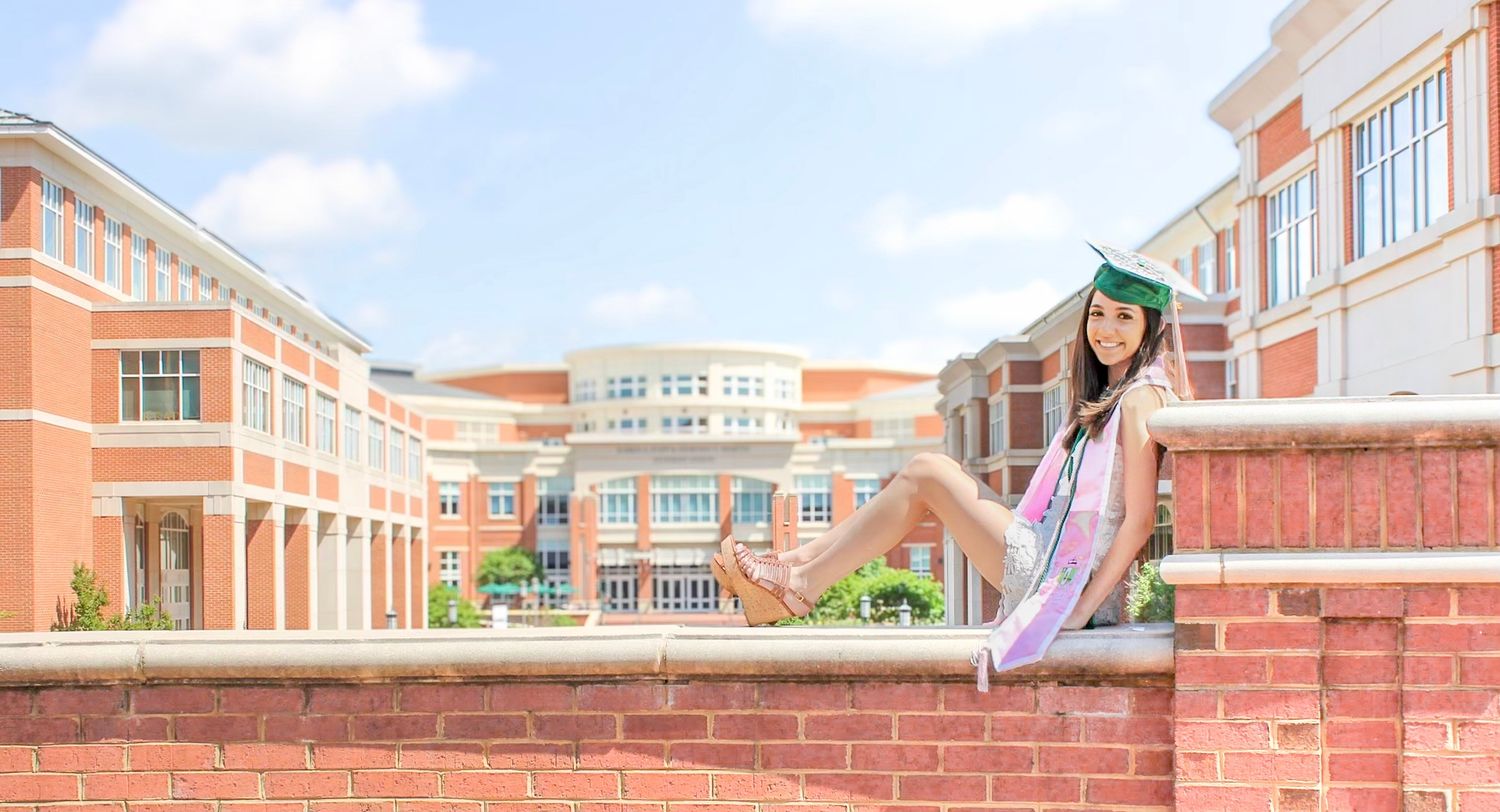 Graduate posing by UNCC student union