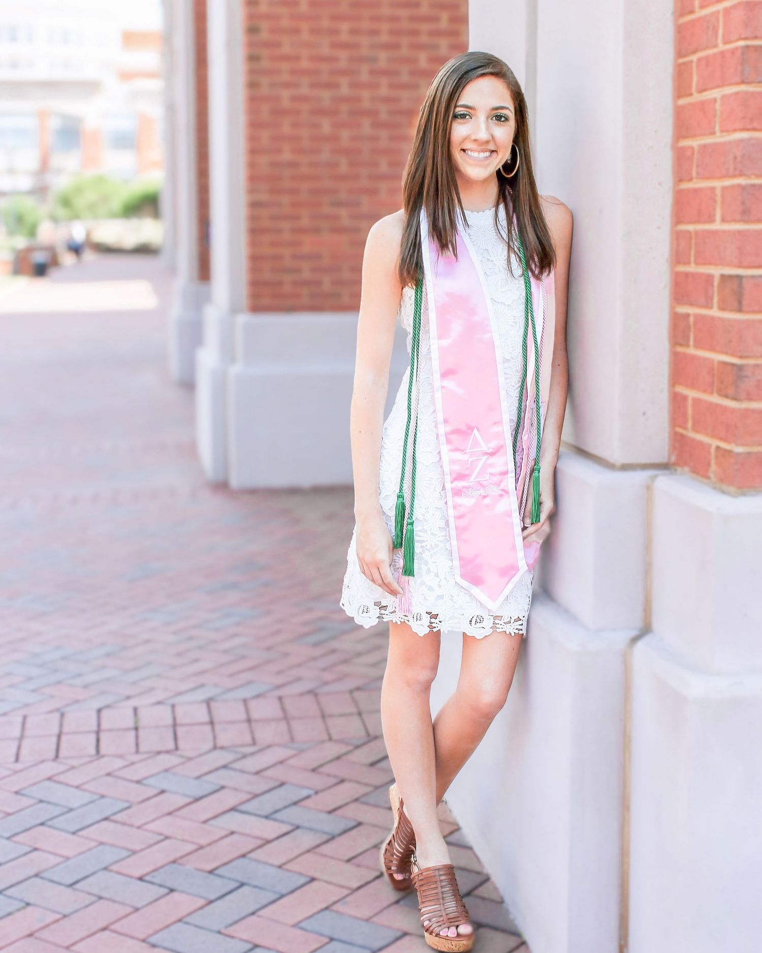 University of North Carolina at Charlotte graduate posing with her Delta Zeta Kappa Phi sash and tassel