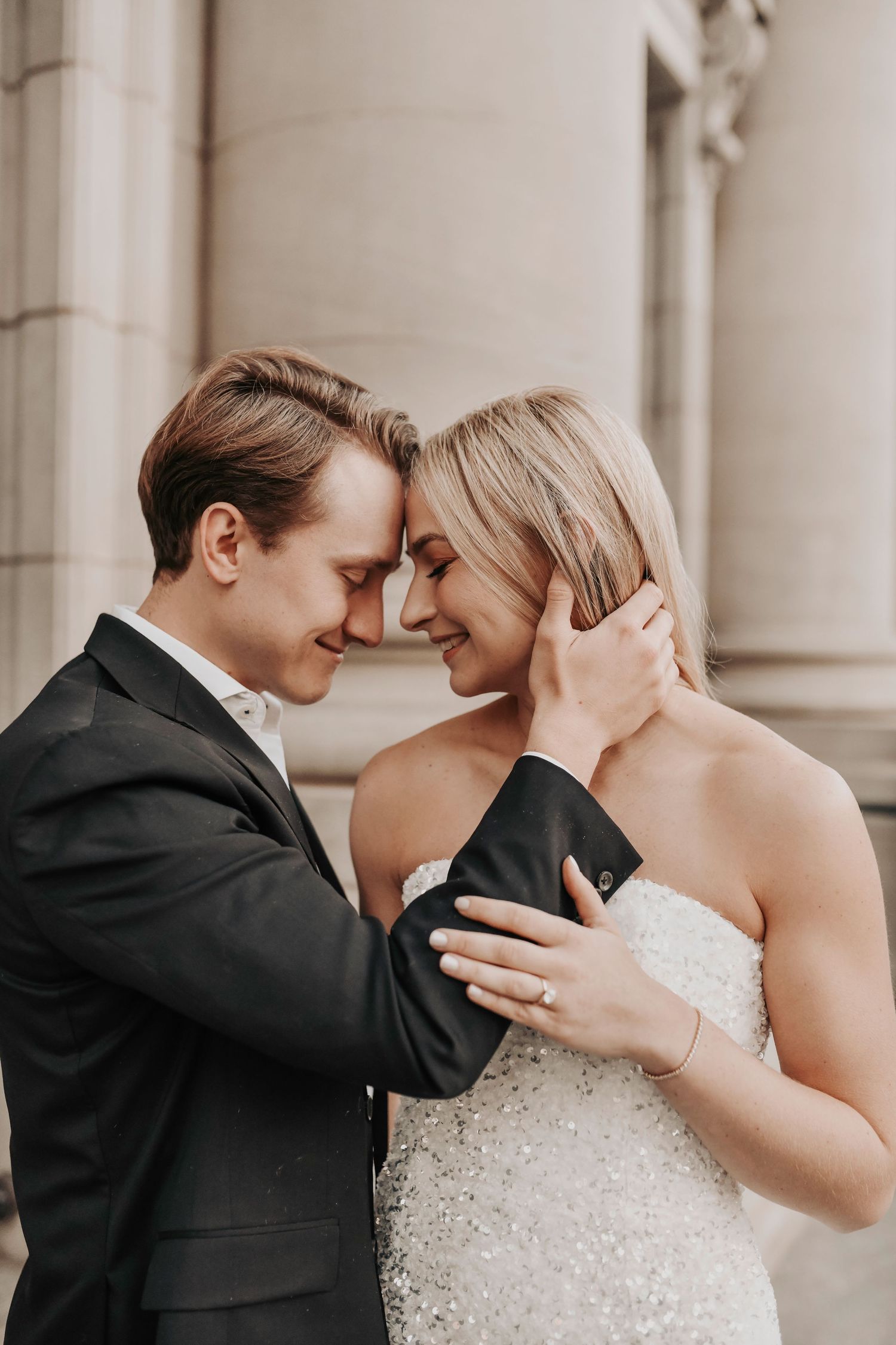 Stylish couple sharing a quiet moment in downtown Dallas during engagement session