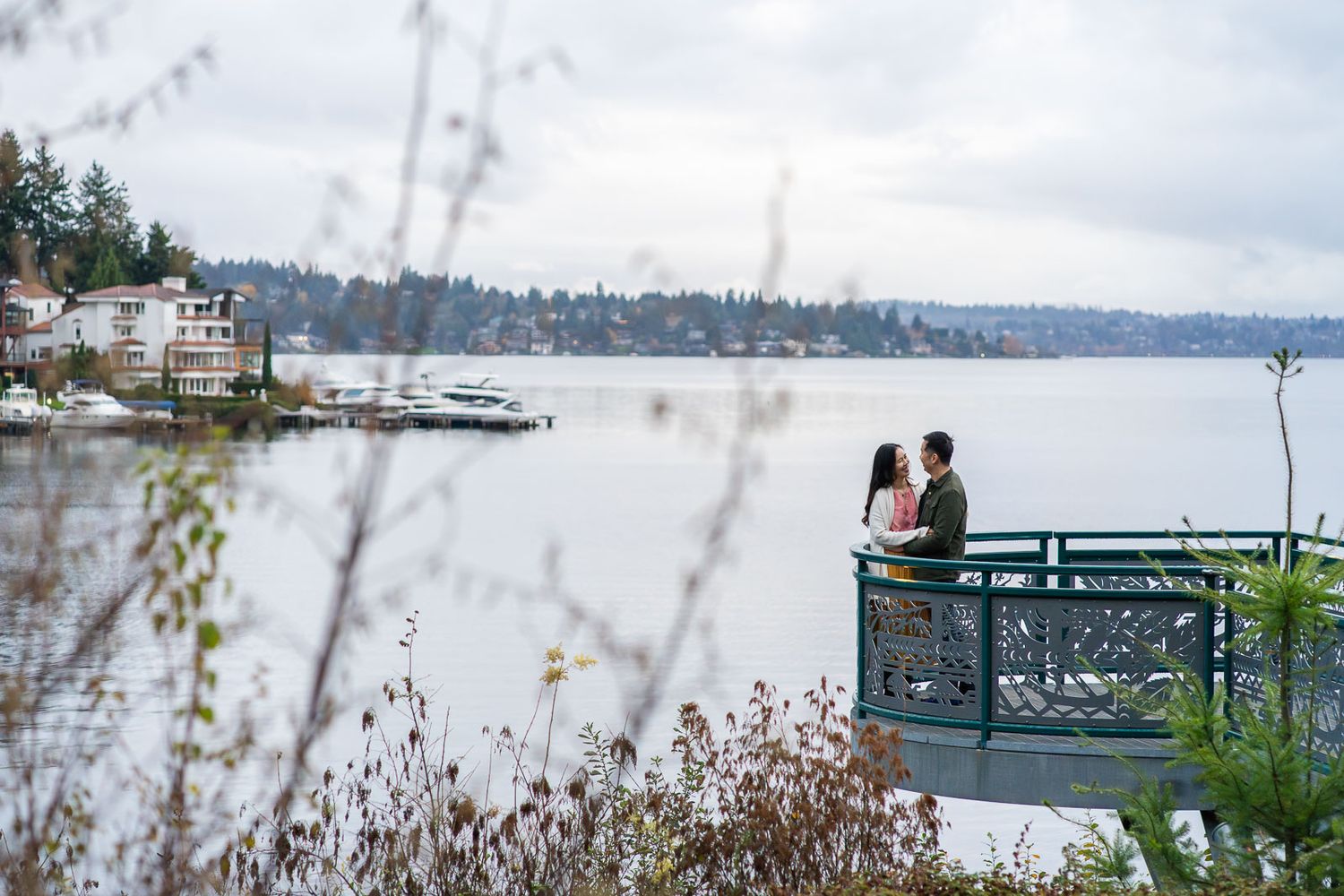 Husband and wife pose for photo at Meydenbauer Bay Park's terrace.
