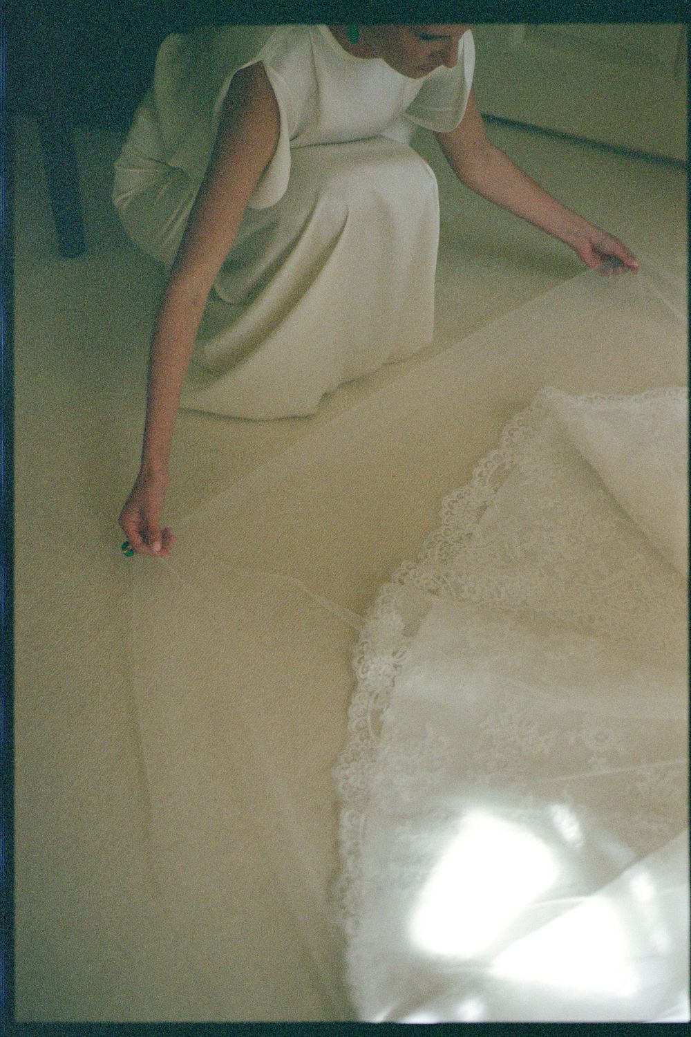 Close-up view of carpet cleaning process showing white foam being scrubbed into beige carpeting.