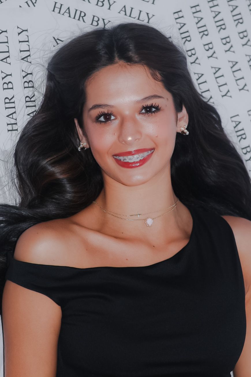 Glamour shots against a text background showing someone in a black top with flowing dark hair.