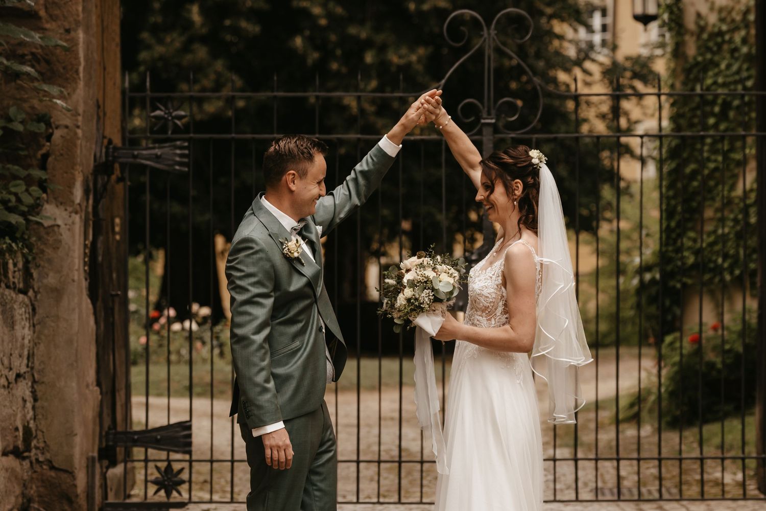 Newlyweds share intimate moments in a romantic garden setting during their wedding photoshoot.