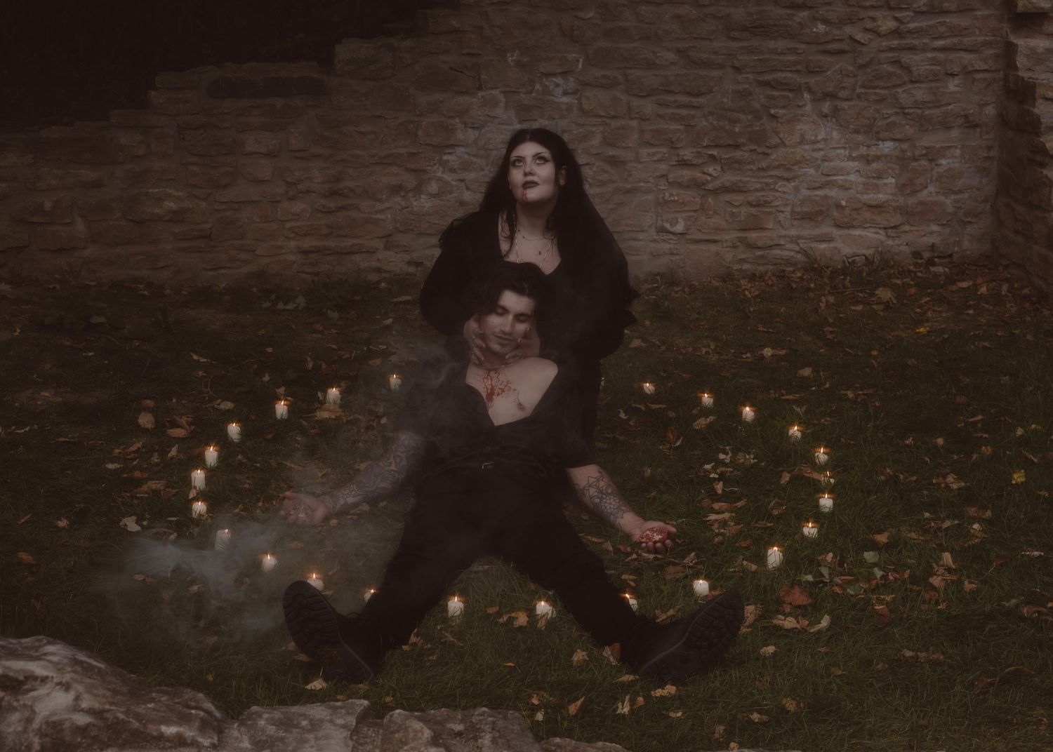 Gothic engagement session shows couple at the haunted Hermitage sitting in the centre of a candle ritual.