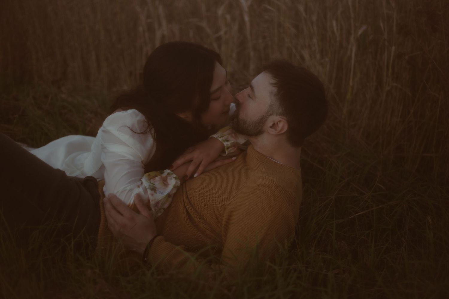 Couple posing during golden hour in Caledonia for moody portraits.