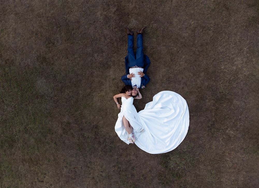 A sequence of aerial shots showing a person in white performing a backflip on dark ground.