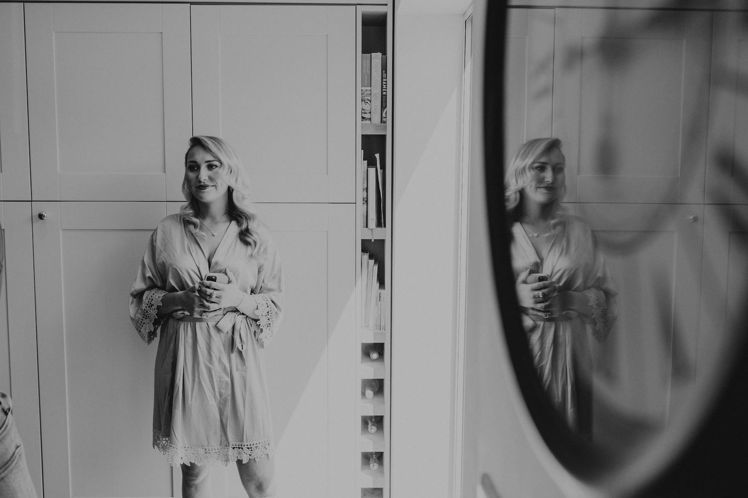 Black and white wedding preparation photos showing getting ready moments in soft natural light.