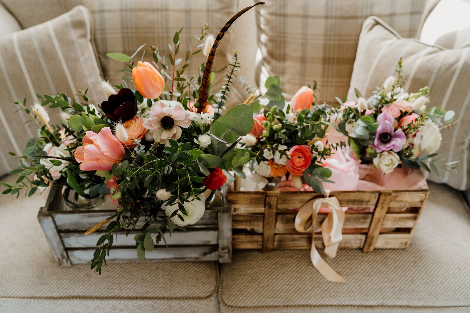 Elegant floral arrangements with coral and pink blooms decorating a wedding venue.