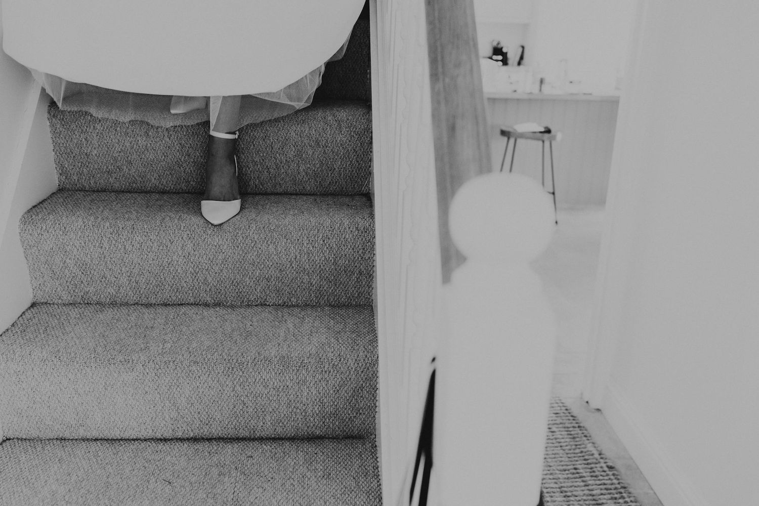 Minimalist black and white photo showing staircase detail at a wedding venue.