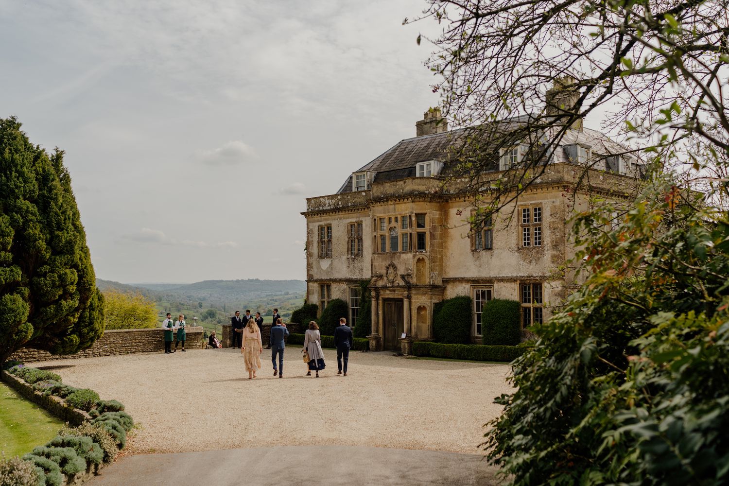 Stone mansion venue with classic architecture overlooking a scenic countryside landscape.