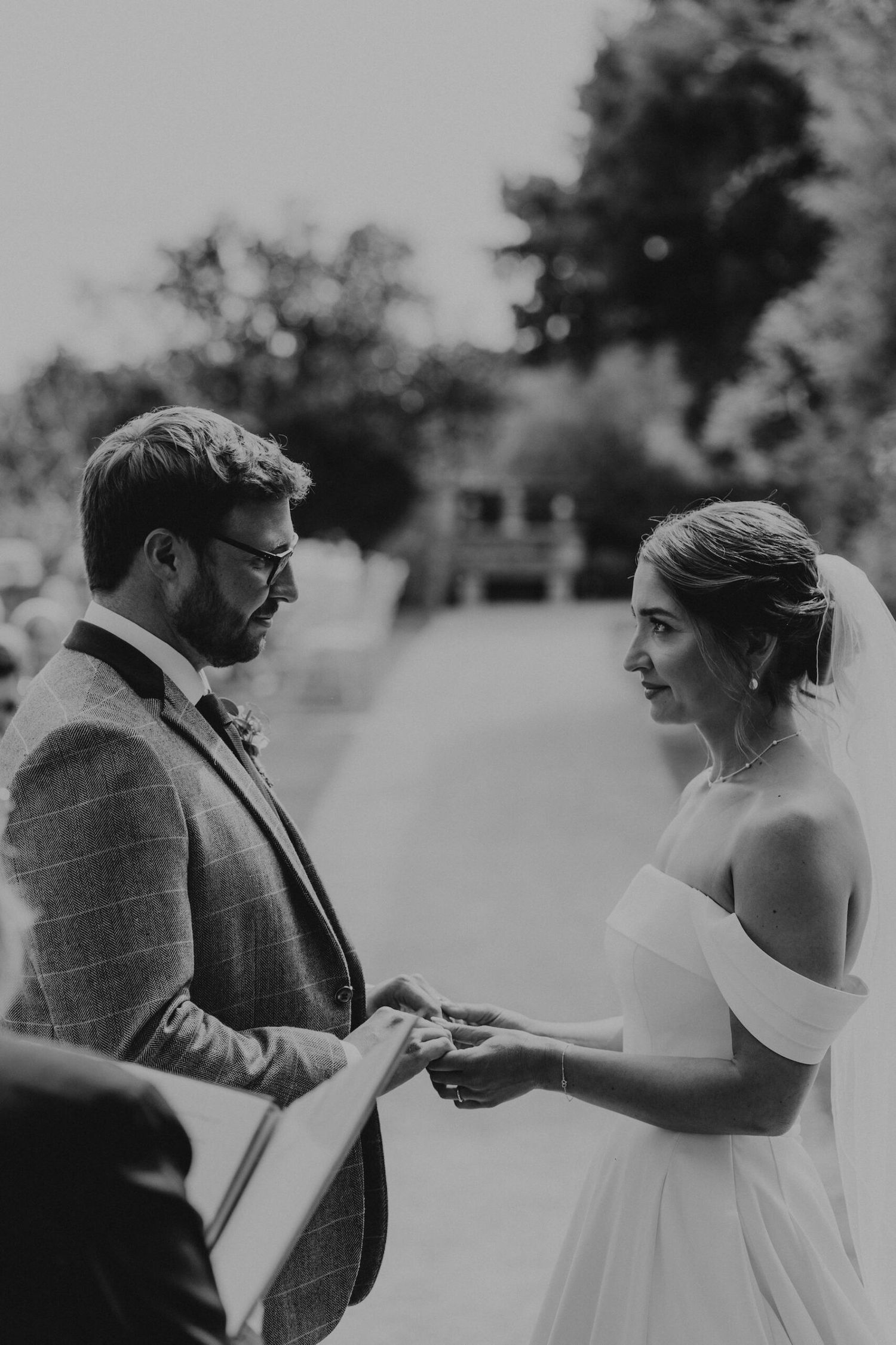 Black and white wedding photo sequence showing a couple's first look moment in an outdoor setting.