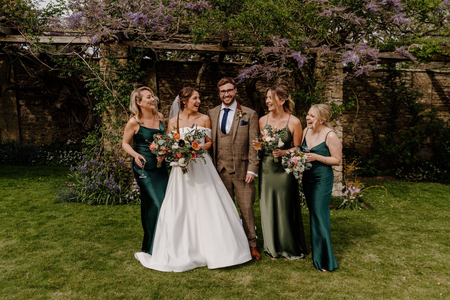 Outdoor garden wedding photos with spring blossoms in background.