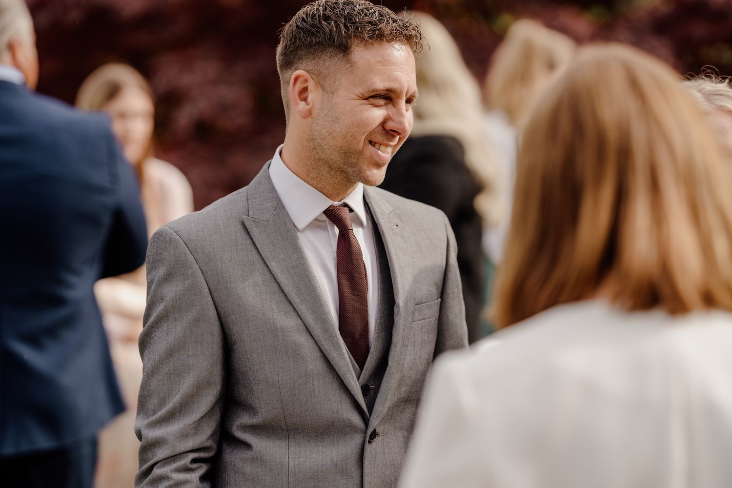 Guests mingle during an elegant outdoor wedding reception.