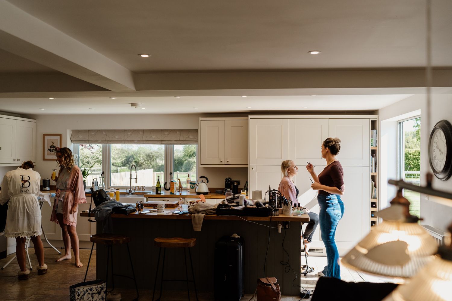 Spacious contemporary kitchen and living area with large windows and modern furnishings.