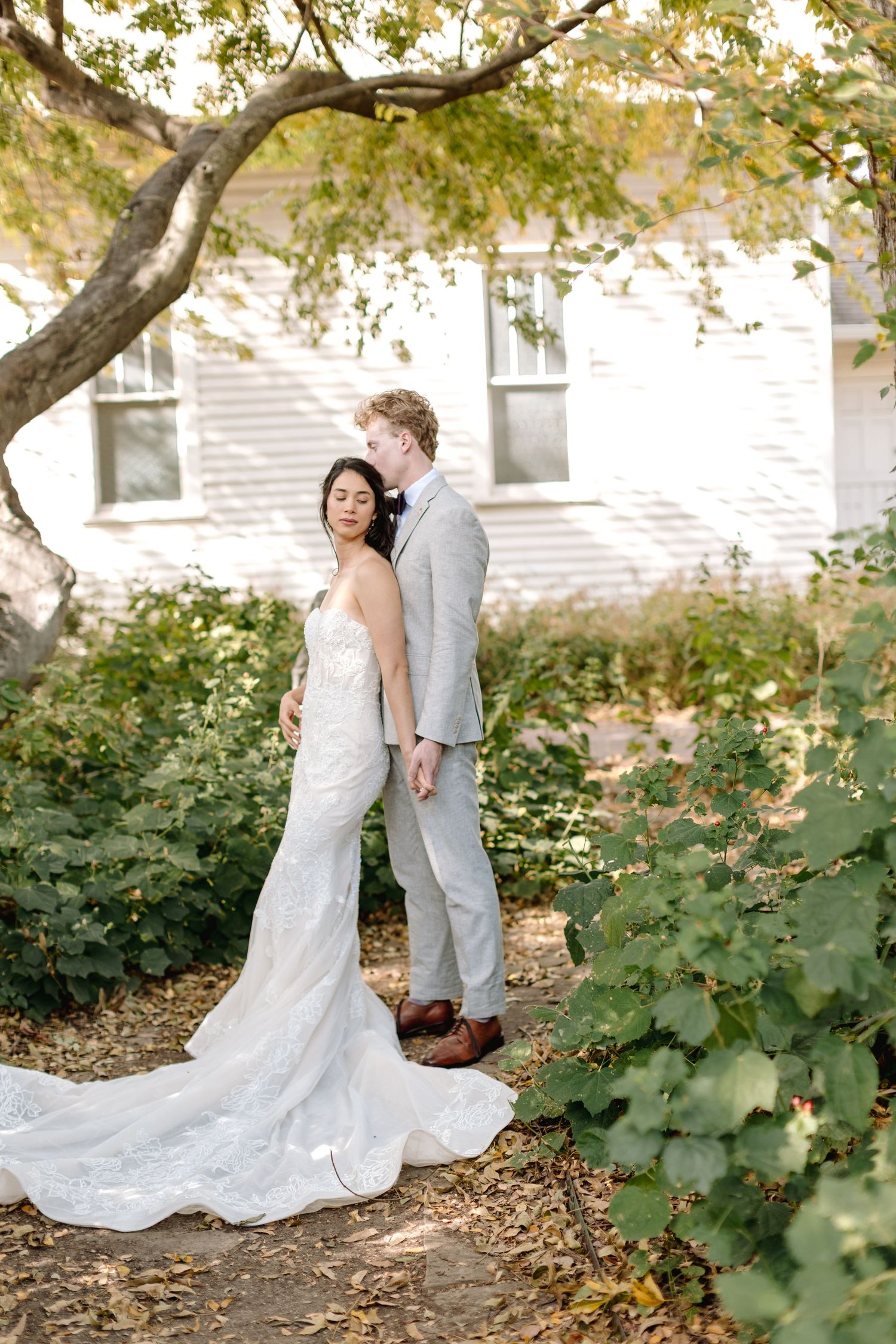 White stone colonnade with decorative architectural details creates an elegant wedding backdrop.