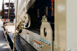 Close-up view of vintage train car detail showing mechanical components and metal surface textures.