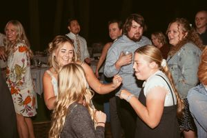 A lively group of party guests dancing and having fun at a nighttime celebration.