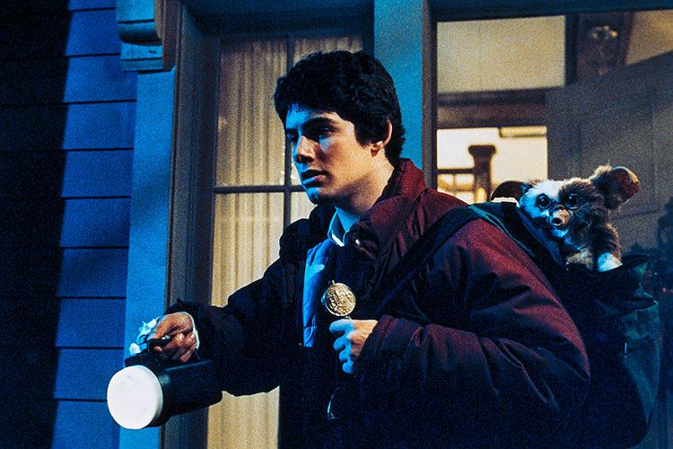 Billy with his flashlight and Gizmo in the backpack