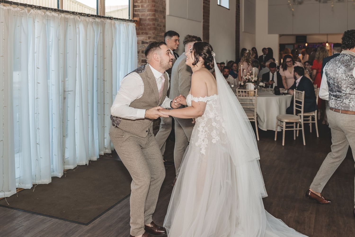 A genuine natural moment a couple enjoy themselves on the dance floor.
