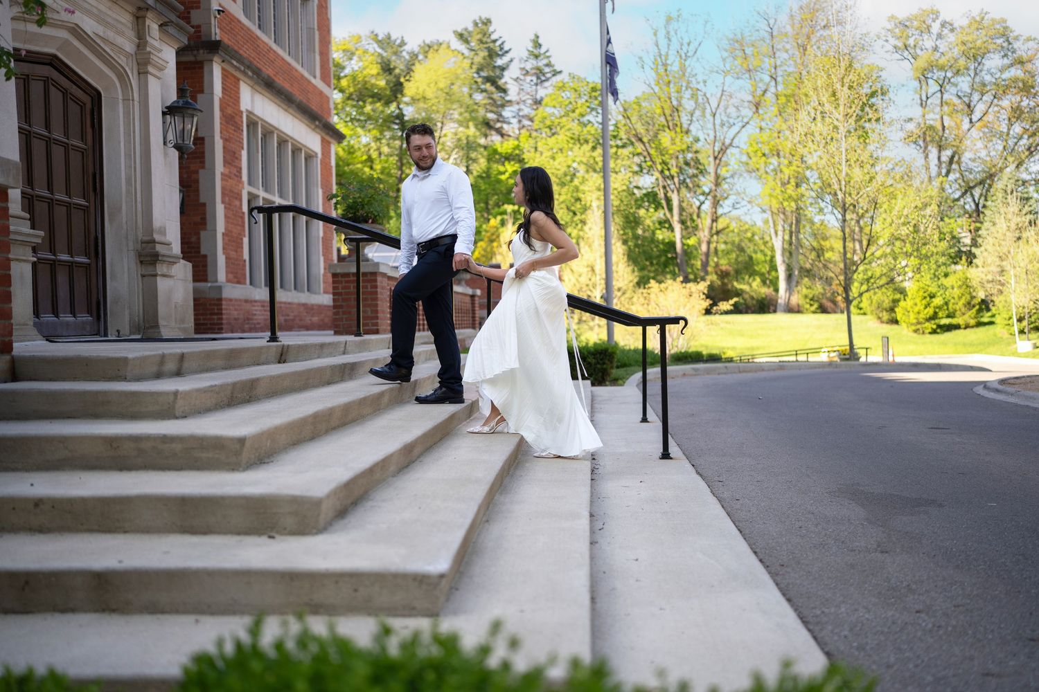 engaged couple walking up stone steps outside Jeffrey Mansion for their Engagement Session